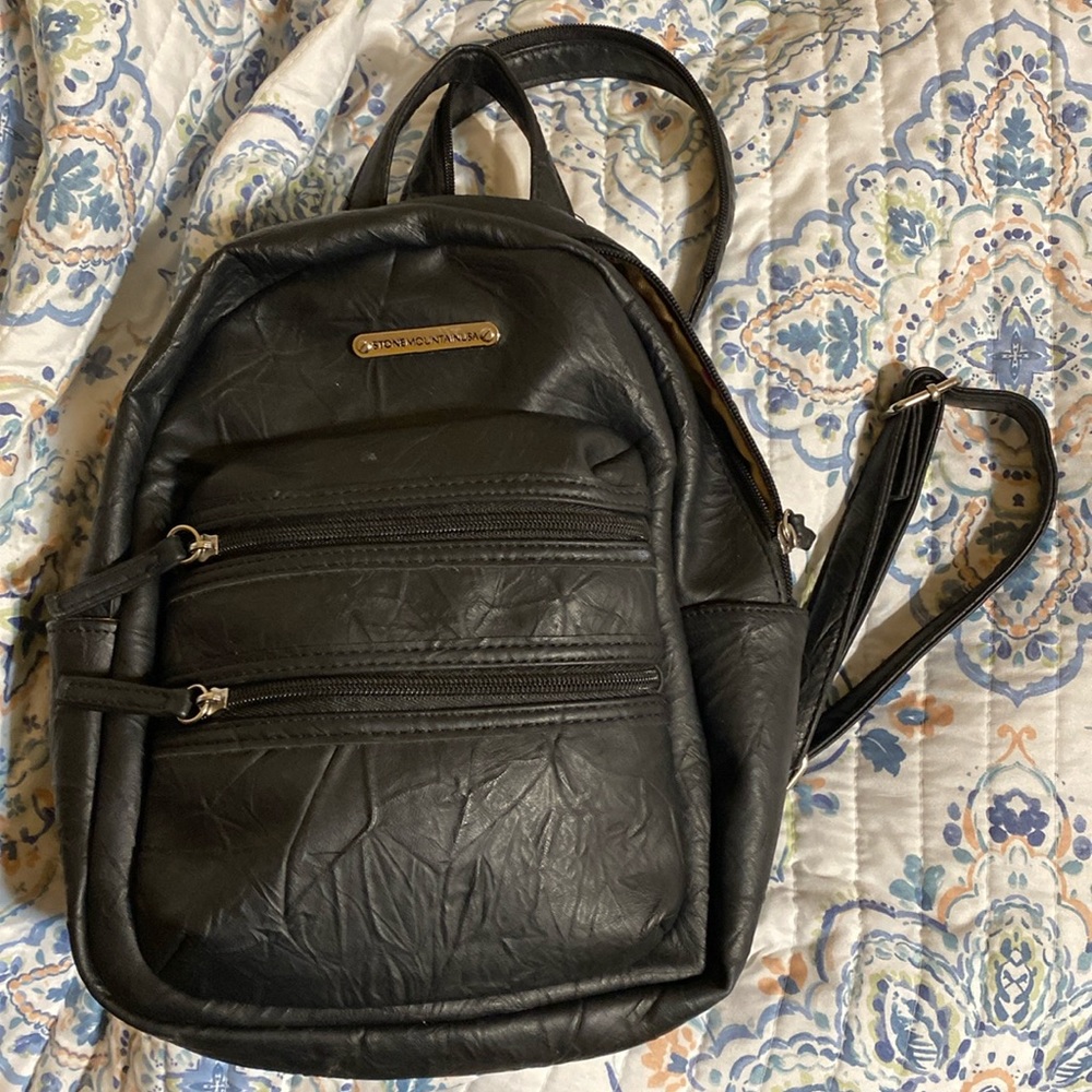 Leather  back pack. One foot long. As new.Holders are adjustable and they zip